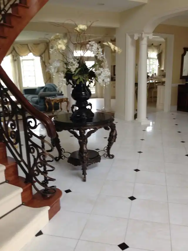 Grand entry with a marble floor and an iron stair rail