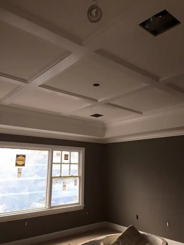 Coffered ceiling above gray walls